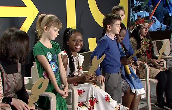 Ms. Banda reads the inscription on her award, which comes from members of her community: “Thank you our fierce fighter, Memory." Image from video feed.